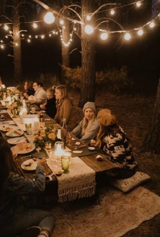 A long table under festoon lights