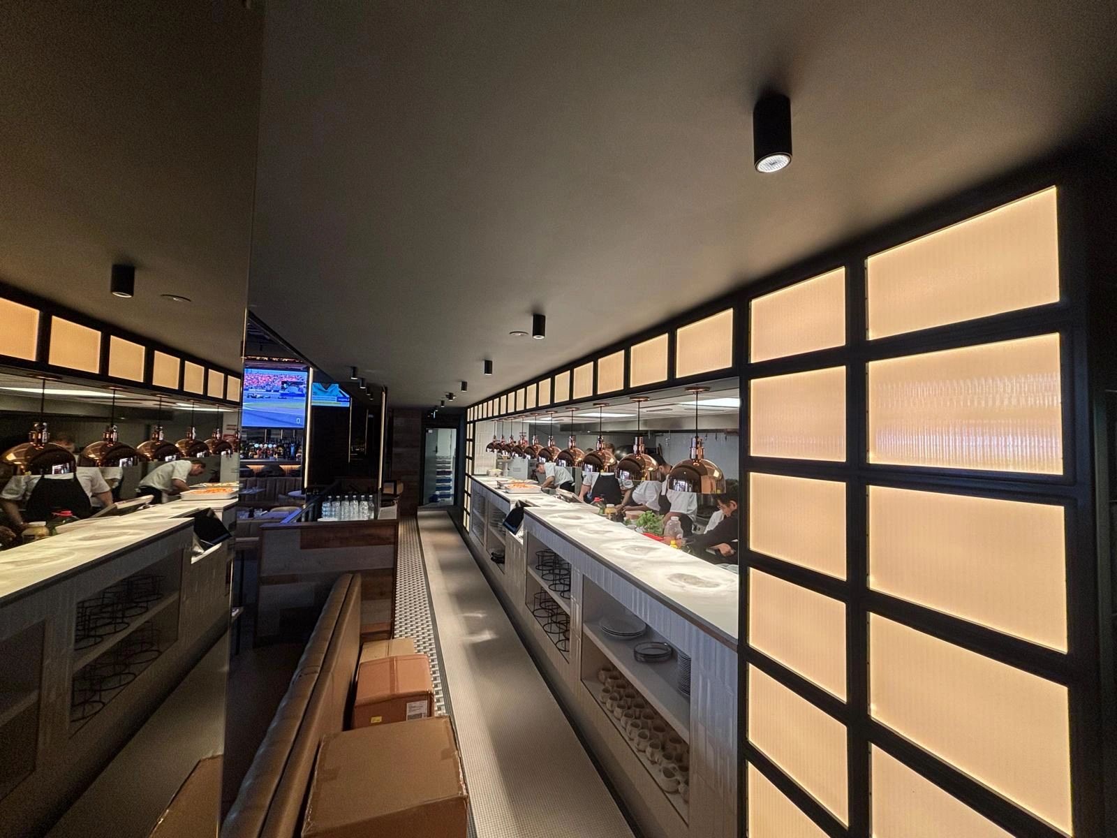 The open kitchen line and pass at La Cage Kensington