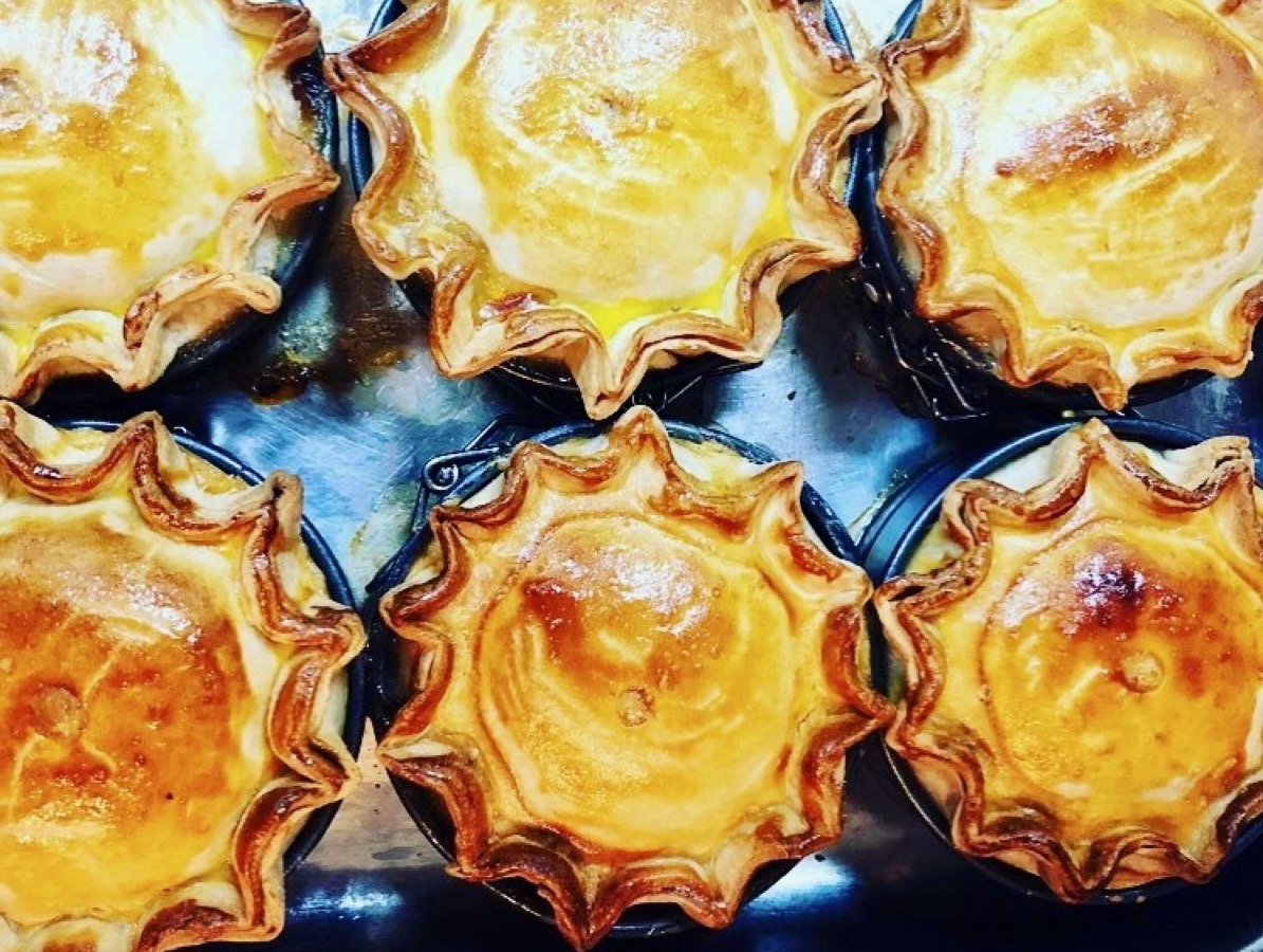 A tray of golden, hand-crimped pies