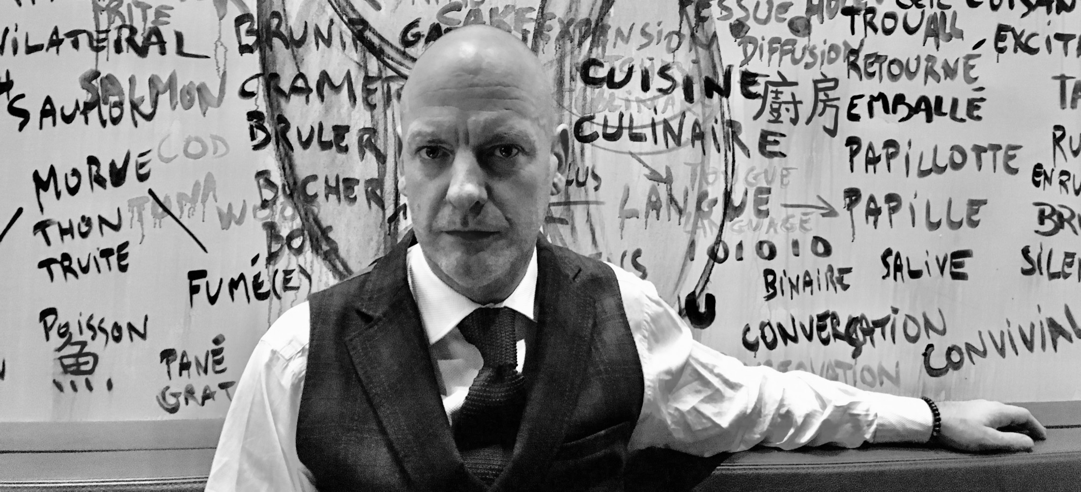 David Peevers against a wall of food and drink words